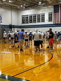 During the week of August 21st, 2023 the Liberty football team practices in the big gym at Liberty Middle School.  All teams were required to move their practices indoors due to the extreme heat that hit Edwardsville, Il. 